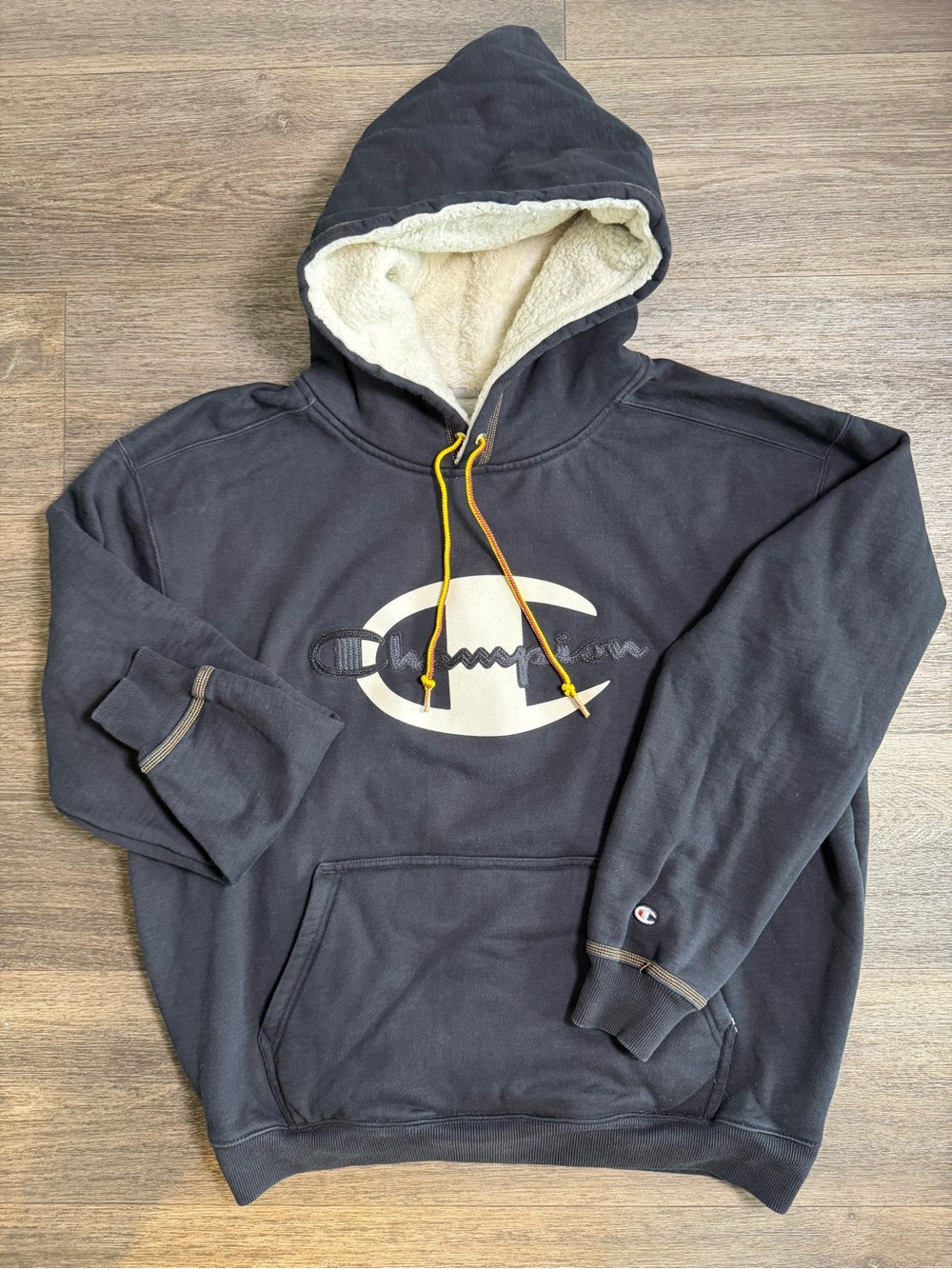 Champion Black Sherpa-Lined Hoodie with Cream Logo and Yellow Drawcords